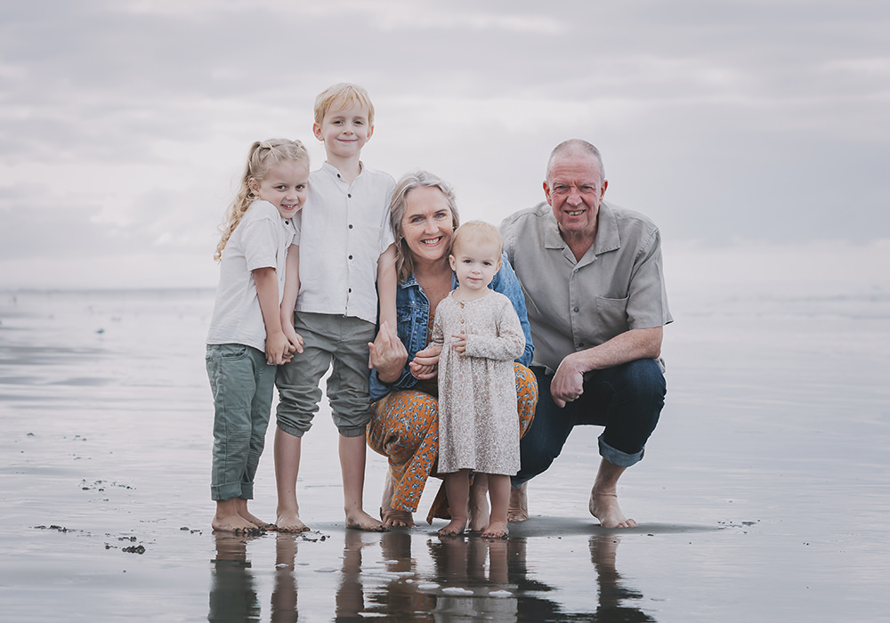 Italy Family Photographer.. Grandparents and Grandchildren in a family portrait on a beach . Italy is a great place for family portraits