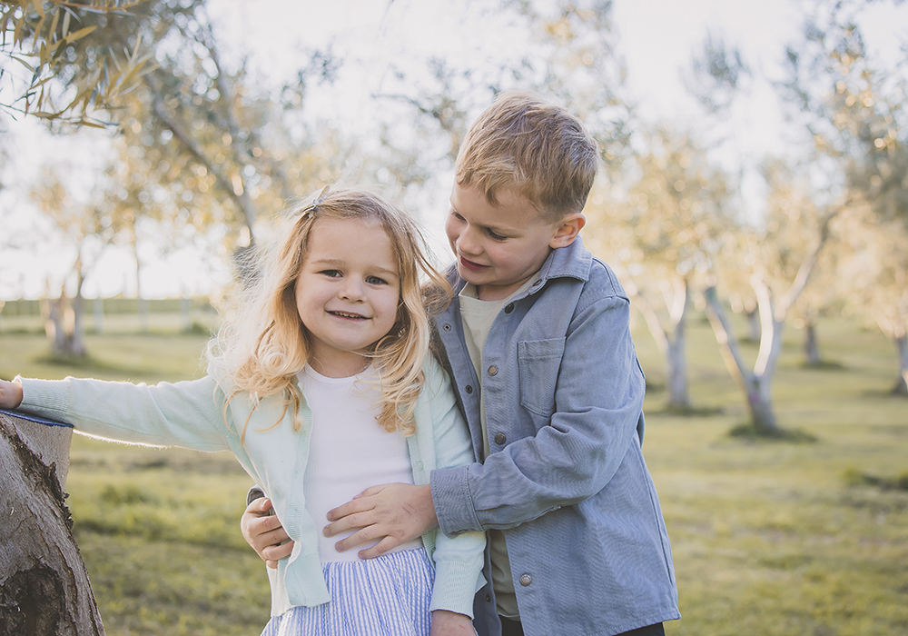 Family portraits Italy olive grove and cypress trees with siblings
