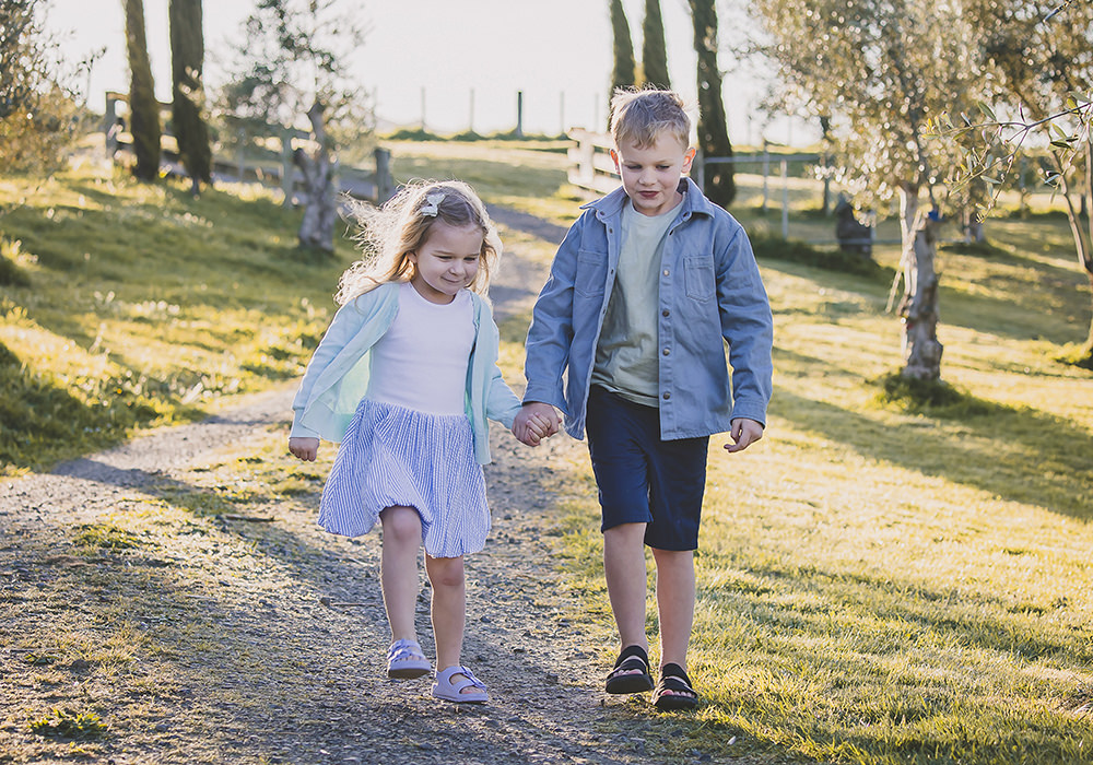 Family portraits Italy olive grove and cypress trees with siblings