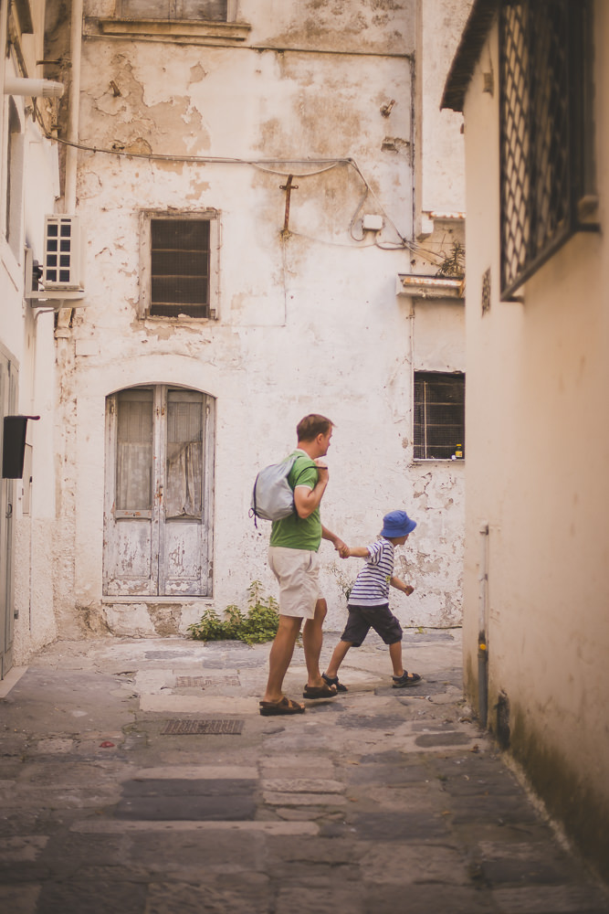 Father and son exploring the backstreets on a family vacation in Italy