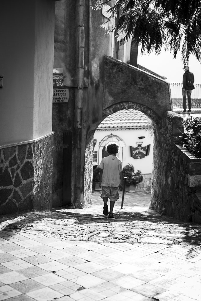 Father and son exploring the backstreets on a family vacation in Italy