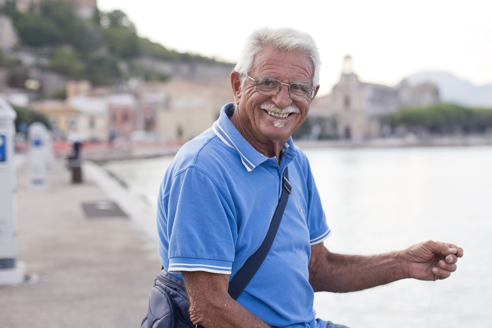 Crab fishing with a local on the promenade of Gaeta.. Family Portraits Italy, Etta Images Italy